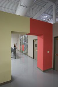 Photo of the interior of a building with a white and red painted arch